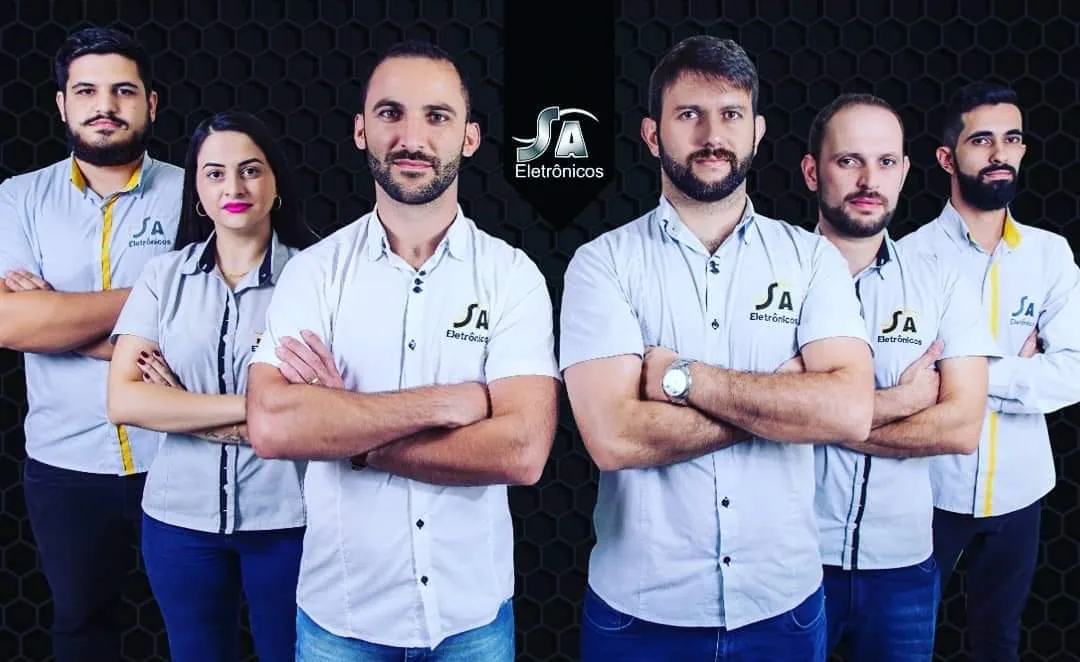 Seis colaboradores da S.A. Eletrônicos em uniforme profissional estoque vendas